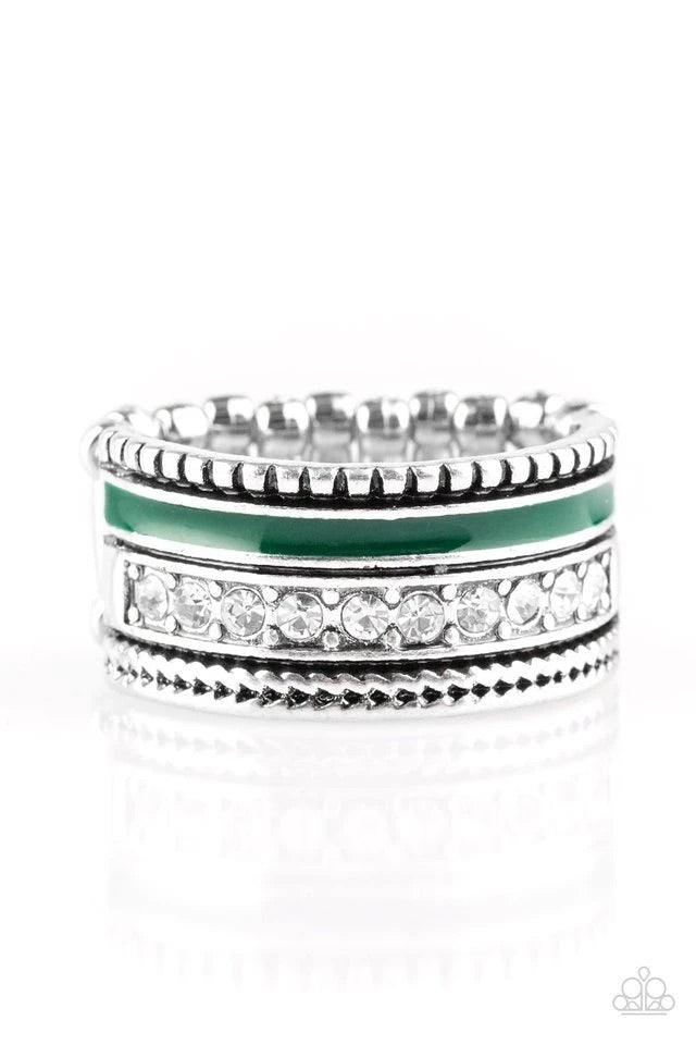 Paparazzi Accessories Rich Rogue - Green Tinted in the rich shade of Quetzal Green, a strip of color runs along the bottom of a row of glassy white rhinestones. Infused with silver textures, the mismatched details coalesce into one thick band across the f