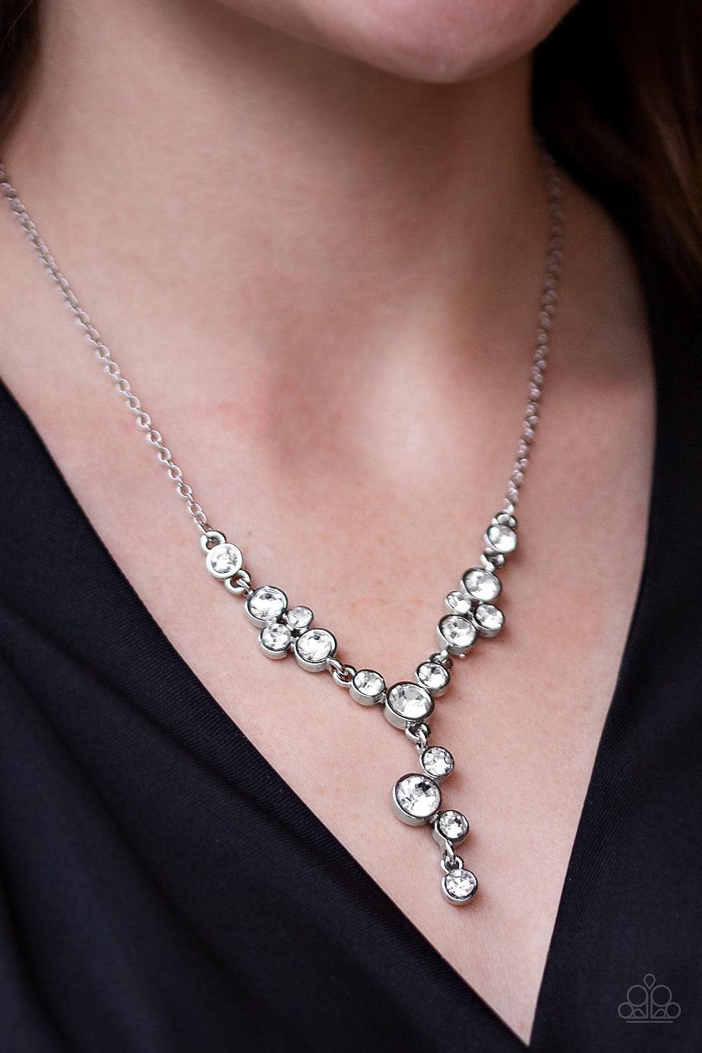 Paparazzi Accessories Five-Star Starlet - White Encased in sleek silver frames, a collection of glittery white rhinestones coalesce into dazzling frames below the collar. Matching rhinestones trickle from the center, creating a glamorous extended pendant.