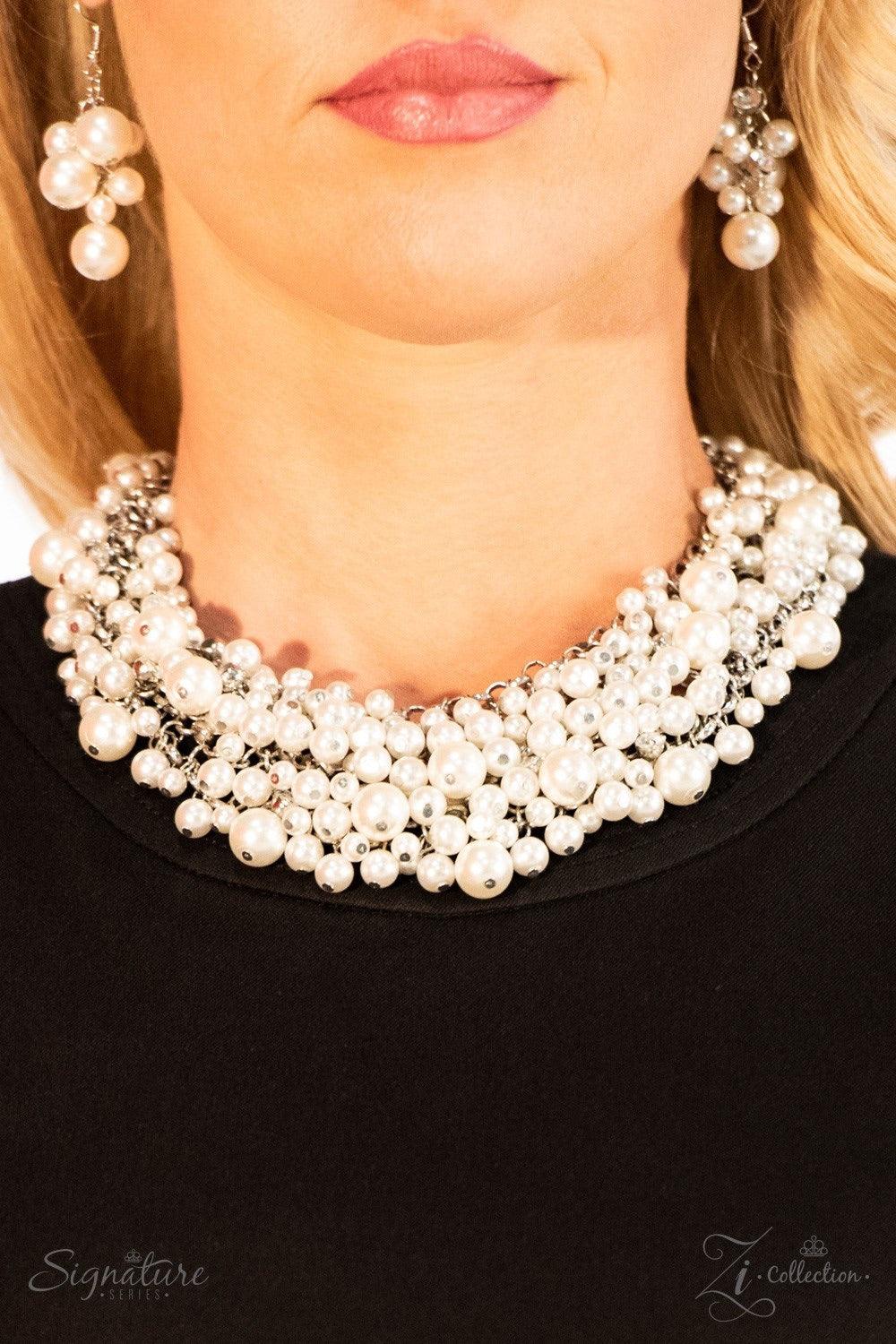 Paparazzi Accessories The Tracey Varying in size, countless white pearls cascade from a web of thick silver chain, creating a bubbly fringe that falls just below the collar. Classic white rhinestones are nestled among the endless sea of pearls, adding hin
