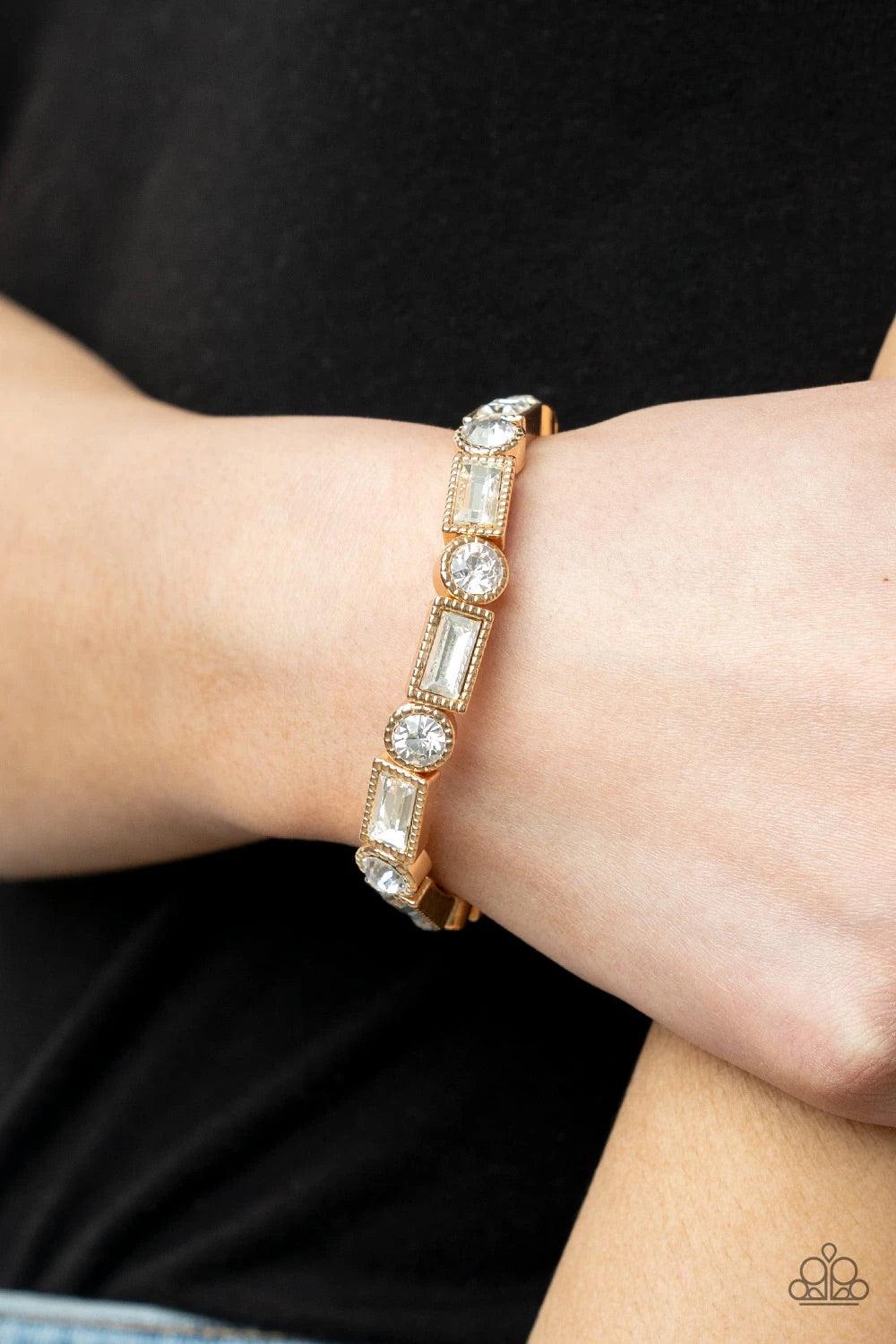Paparazzi Accessories Classic Couture - Gold Classic round and baguette cut rhinestones set in shiny dotted gold frames alternate around the wrist on stretchy bands for a shimmering finish. Sold as one individual bracelet. Jewelry