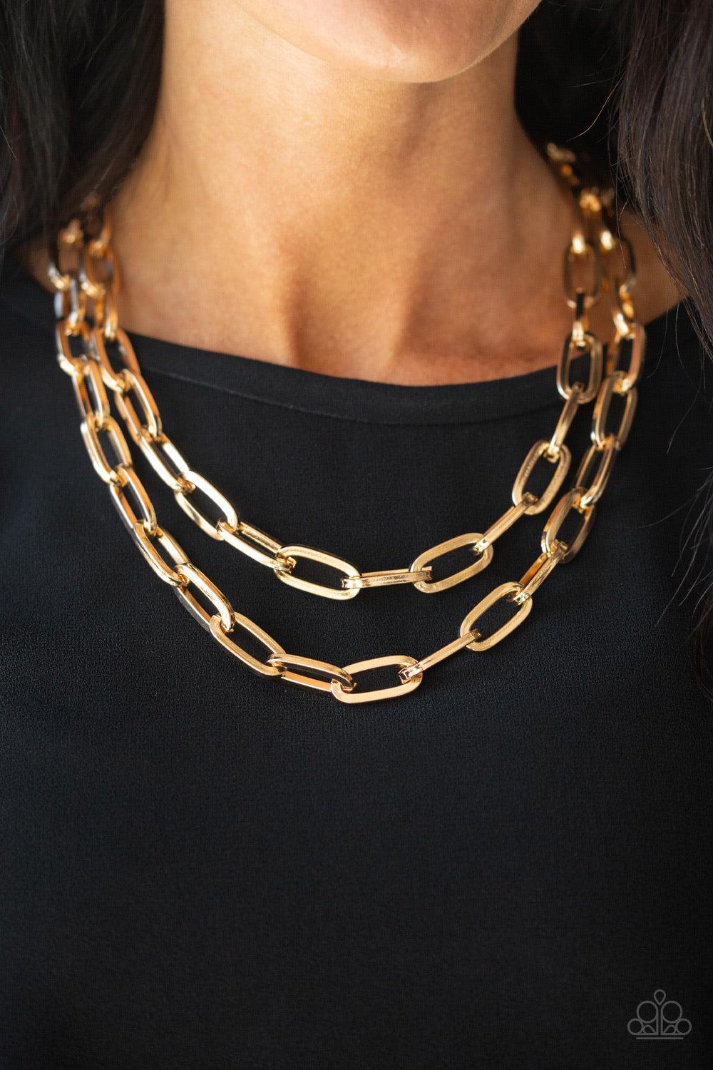 Paparazzi Accessories Make A CHAINge - Gold Dramatically oversized gold links connect below the collar, creating two bold layers below the collar for a knockout look. Features an adjustable clasp closure. Jewelry