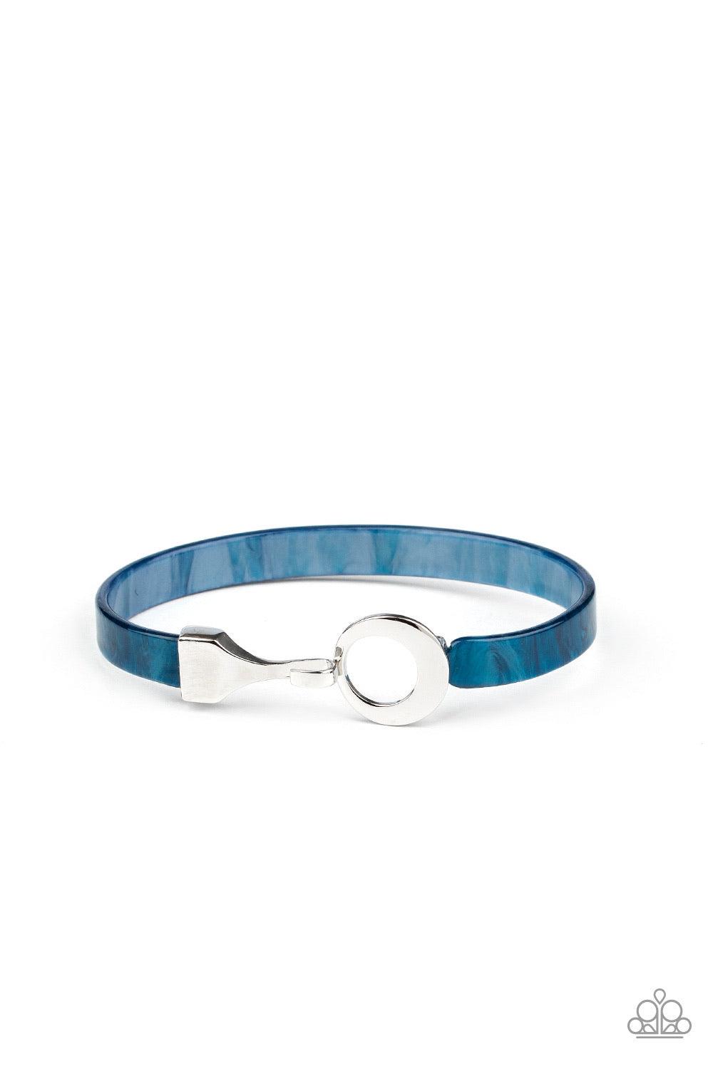 Paparazzi Accessories HAUTE Button Topic - Blue Featuring a shell-like shimmer, a dainty blue acrylic band curls around the wrist, connecting to a silver hinged fitting at the center. Features a hinged closure. Sold as one individual bracelet. Jewelry