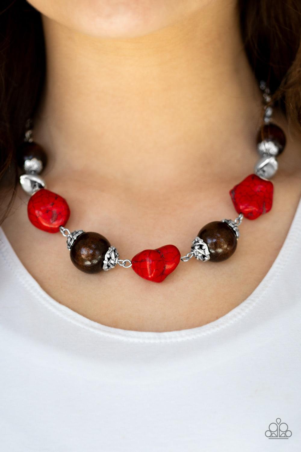 Paparazzi Accessories Earth Goddess - Red Infused with ornate silver accents, red stones and round wooden beads trickle along a shimmering silver chain, creating an artisanal statement piece that falls just below the collar. Features an adjustable clasp c