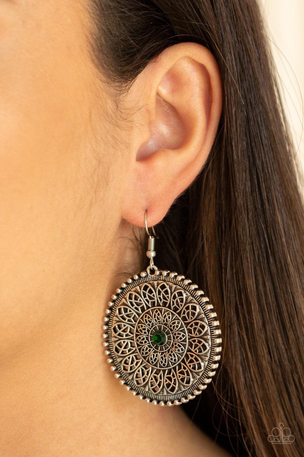 Paparazzi Accessories WHEEL and Grace - Green A dainty green rhinestone is pressed into the center of a round silver frame radiating with ornate petals, creating a frilly frame. Earring attaches to a standard fishhook fitting. Jewelry