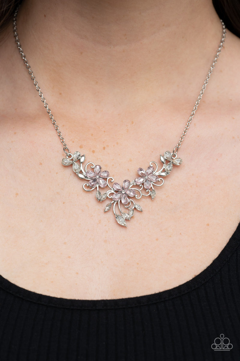 Paparazzi Accessories Floral Fashion Show - Pink A twinkly trio of pink rhinestone petaled flowers bloom atop a leafy silver backdrop adorned in marquise cut white rhinestones, resulting in a timeless floral centerpiece below the collar. Features an adjus
