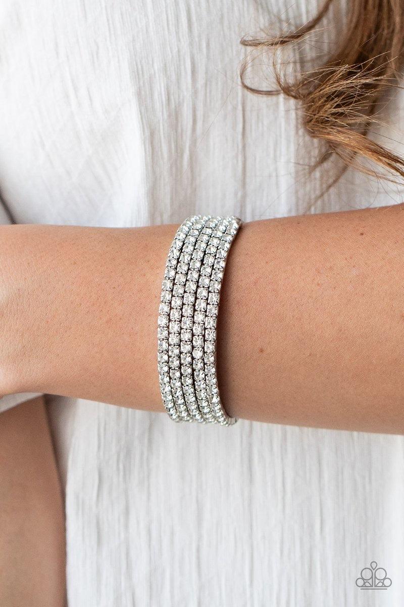 Paparazzi Accessories The GLOW-Digger - White Encased in sleek silver fittings, row after row of glassy white rhinestones coil around the wrist, creating a blinding infinity wrap bracelet. Jewelry