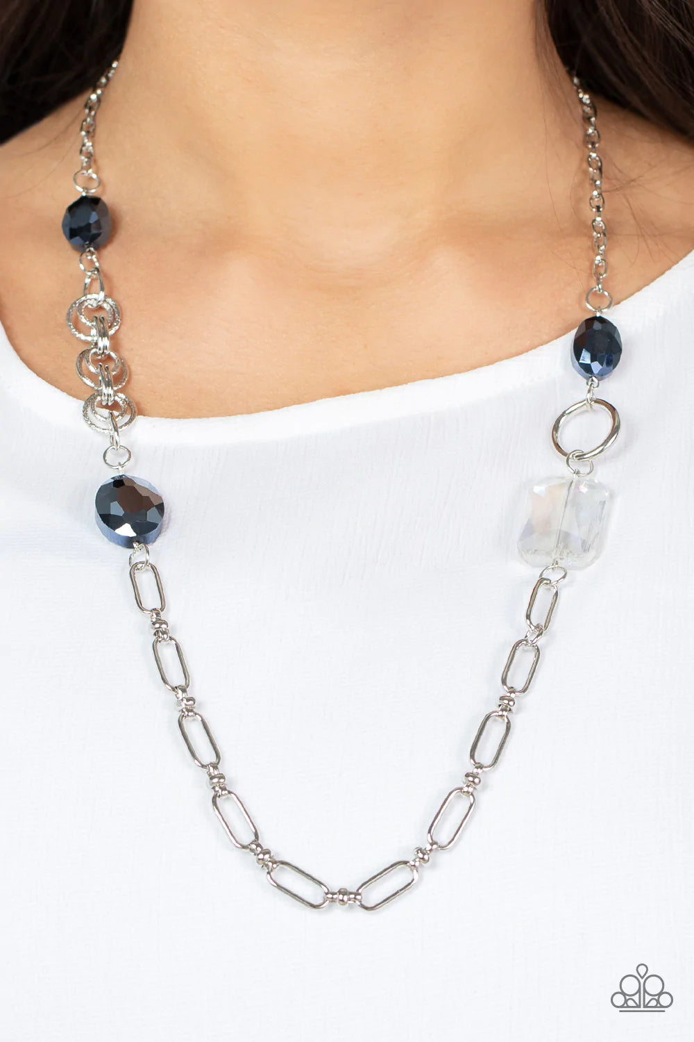 Paparazzi Accessories Famous and Fabulous - Blue A mismatched assortment of oval, round, textured, and silver hoops haphazardly link into a chaotic chain below the collar. Featuring oval and emerald style cuts, oversized metallic blue and iridescent gems