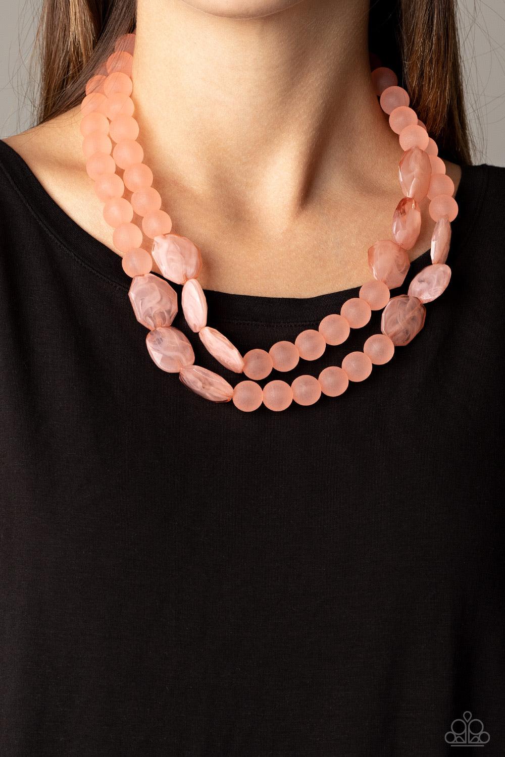 Paparazzi Accessories Arctic Art - Pink Featuring round and imperfectly flat shapes, an icy compilation of opaque Rose Tan beads are threaded along invisible wires, creating colorfully glassy layers below the collar. Features an adjustable clasp closure.
