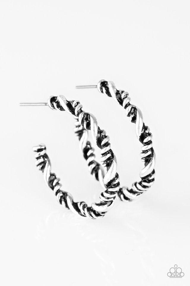 Paparazzi Accessories Plainly Panama - Silver Featuring smooth and serrated textures, glistening silver ribbons twist into a shimmery silver hoop for a tribal inspired look. Earring attaches to a standard post fitting. Hoop measures 1" in diameter. Jewelr