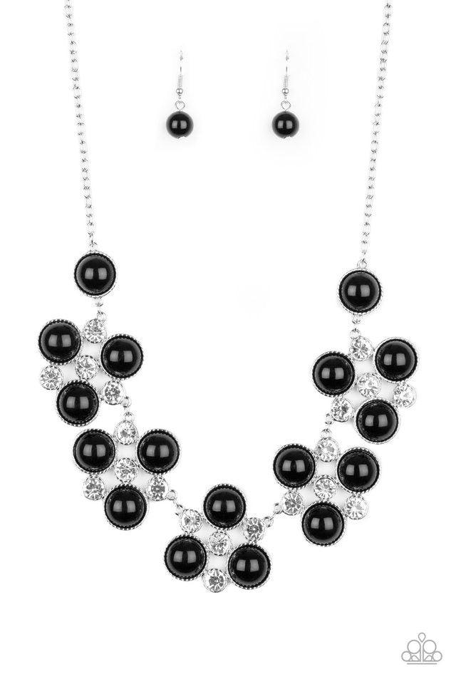 Paparazzi Accessories Night At The Symphony - Black Sleek silver frames adorned in a refined mix of oversized black beads and glassy white rhinestones, delicately link below the collar for a dramatically glamorous look. Features an adjustable clasp closur