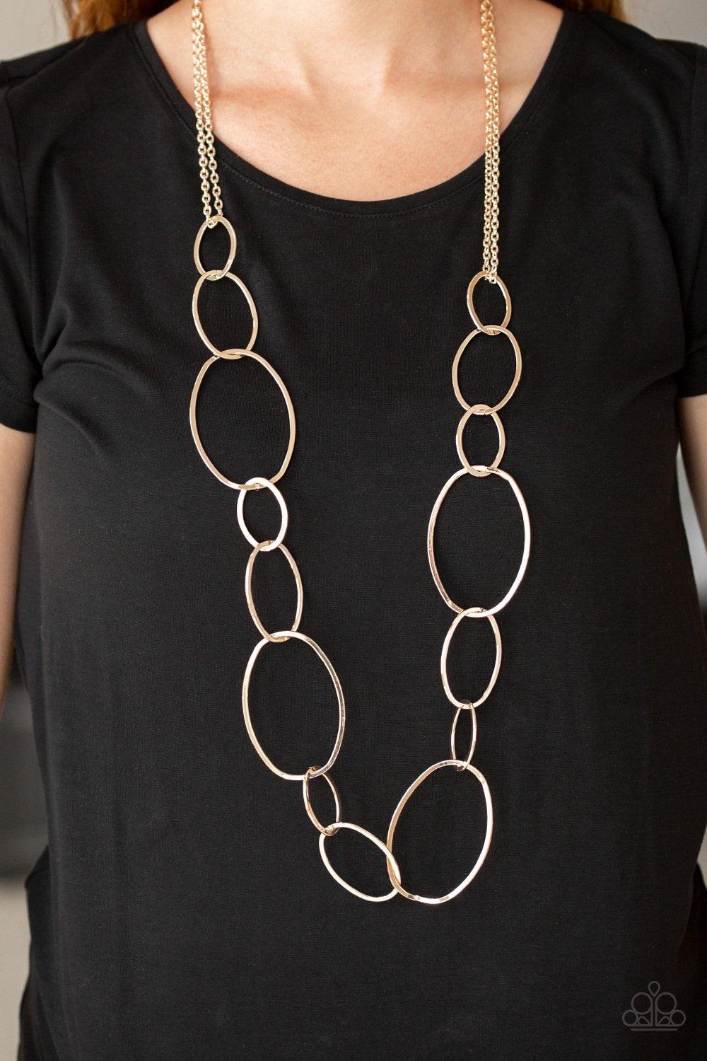 Paparazzi Accessories City Circuit - Gold Swinging from doubled rose gold chains, oversized asymmetrical hoops dramatically link across the chest for a refined industrial look. Features an adjustable clasp closure. Sold as one individual necklace. Include