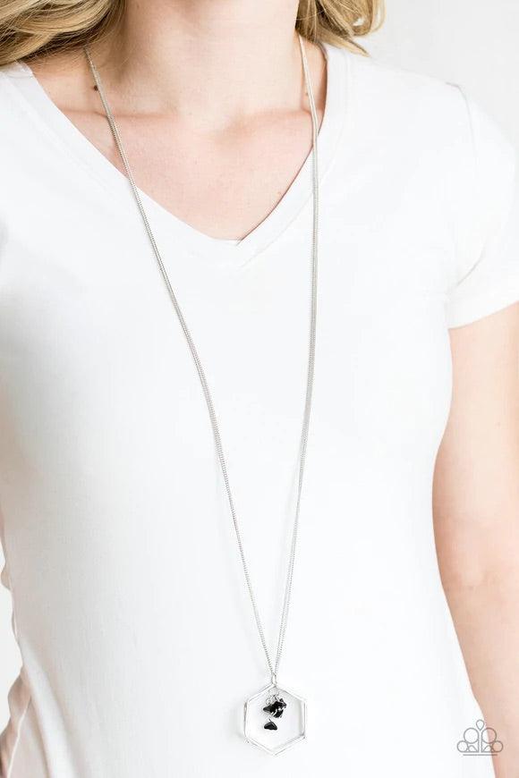 Paparazzi Accessories Chicly Geocentric - Black A trio of hexagonal frames swing from the bottom of a lengthened silver chain. A tassel of glassy black pyramidal beads swings from the geometric pendant for an edgy look. Features an adjustable clasp closur