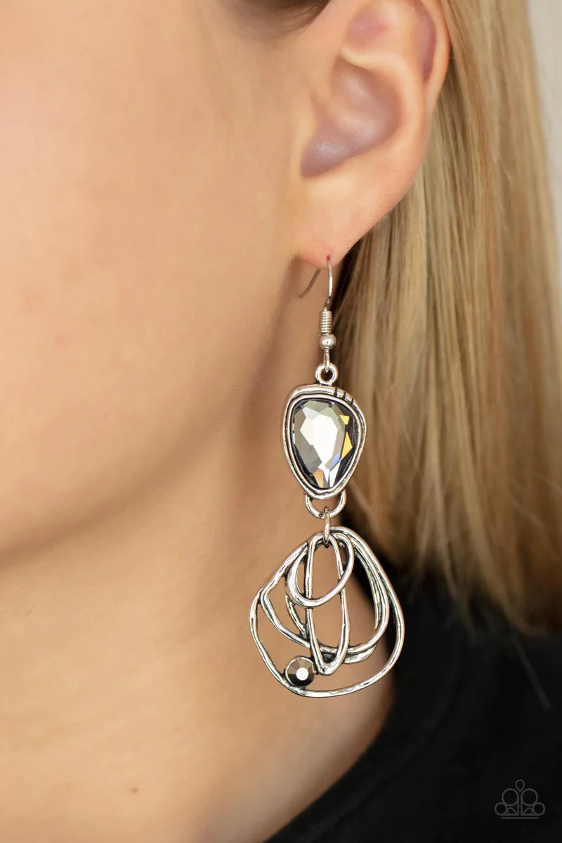 Paparazzi Accessories Galactic Drama - Black Encased in a stacked silver frame, an asymmetrical smoky gem gives way to a dizzyingly abstract silver frame dotted with a single hematite rhinestone for an edgy finish. Earring attaches to a standard fishhook