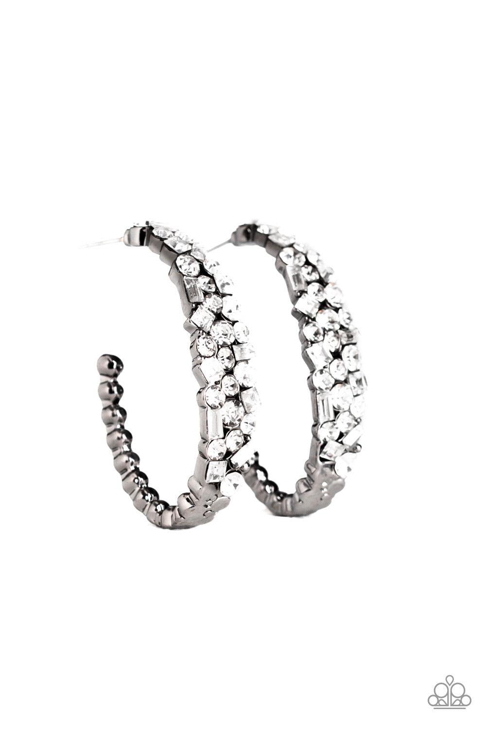 Paparazzi Accessories The Glitzy Conscience - Black The front of a hook-shaped gunmetal hoop is encrusted in a collision of glassy white rhinestones for a blinding look. Earring attaches to a standard post fitting. Hoop measures approximately 1" in diamet