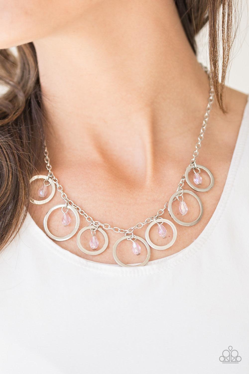 Paparazzi Accessories Rochester Refinement - Pink Faceted pink crystal-like beads swing from the tops of shimmery silver hoops. Slightly varying in size, the shiny silver hoops swing from the bottom of a bold silver chain, creating a refined fringe below