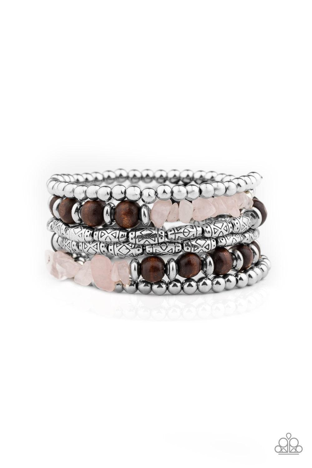 Paparazzi Accessories Soul Searchin - Pink A collection of shiny silver beads, glassy pink stones, wooden beads, and ornate silver accents are threaded along a coiled wire, creating an earthy infinity wrap style bracelet around the wrist. Jewelry