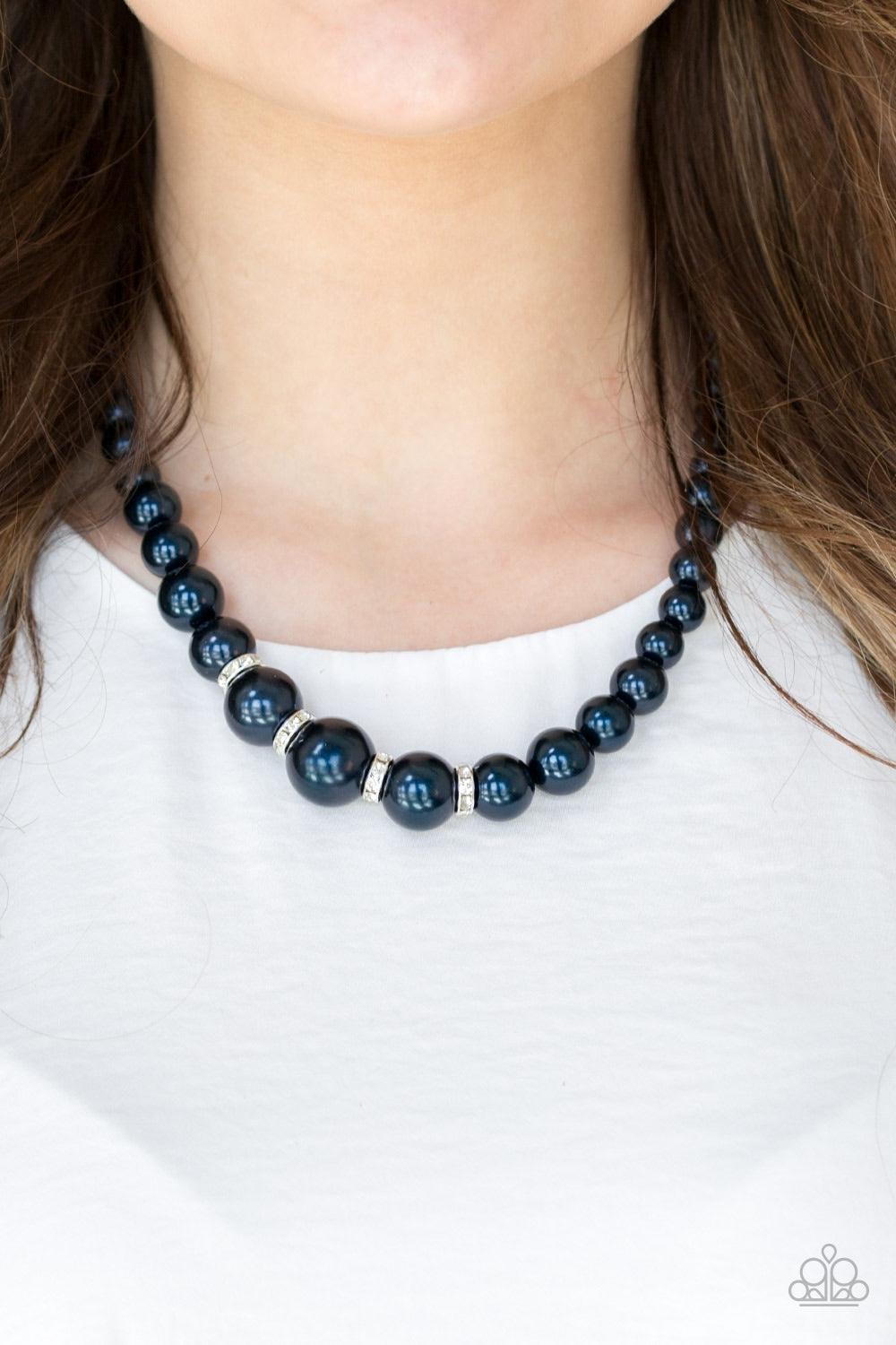 Paparazzi Accessories Party Pearls - Blue Gradually increasing in size, luminescent blue pearls trickle below the collar for a classic look. Encrusted in dazzling white rhinestones, glittery rings are sprinkled between the pearls for a timeless finish. Fe