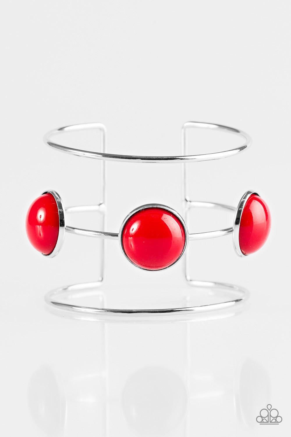 Paparazzi Accessories Lush Lagoon - Red Three shimmery silver bars arc across the wrist, coalescing into an airy cuff. Three fiery red beads are pressed into the centermost bar for a bubbly finish. Jewelry