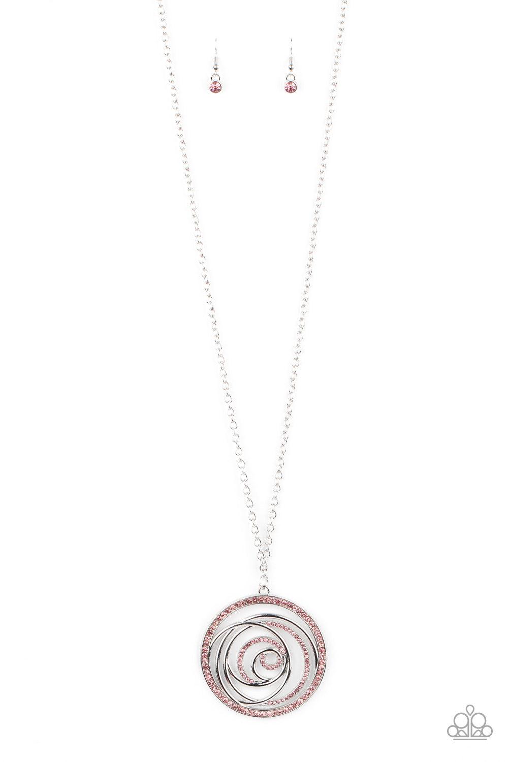 Paparazzi Accessories Subliminal Sparkle - Pink Encrusted in sections of glittery pink rhinestones, glistening silver bars swirl inside a pink rhinestone encrusted circle, creating a dizzying pendant at the bottom of a lengthened silver chain. Features an