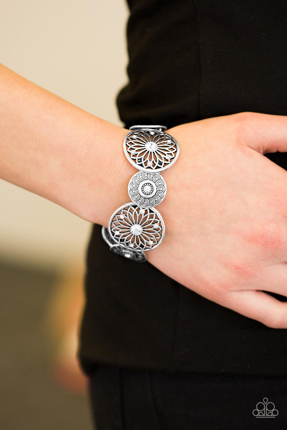Paparazzi Accessories Love Wheel Find A Way - White Dotted in glittery white rhinestone centers, mismatched silver frames are threaded along elastic stretchy bands, creating a decorative shimmer around the wrist. Sold as one individual bracelet. Jewelry