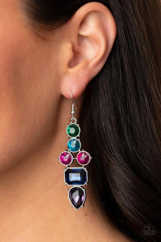 Paparazzi Accessories Look At Me GLOW! - Blue Featuring emerald, round, and teardrop shapes, a sparkly series of green, blue, pink, and purple rhinestones coalesce into a dramatically regal lure. Earring attaches to a standard fishhook fitting. Sold as on