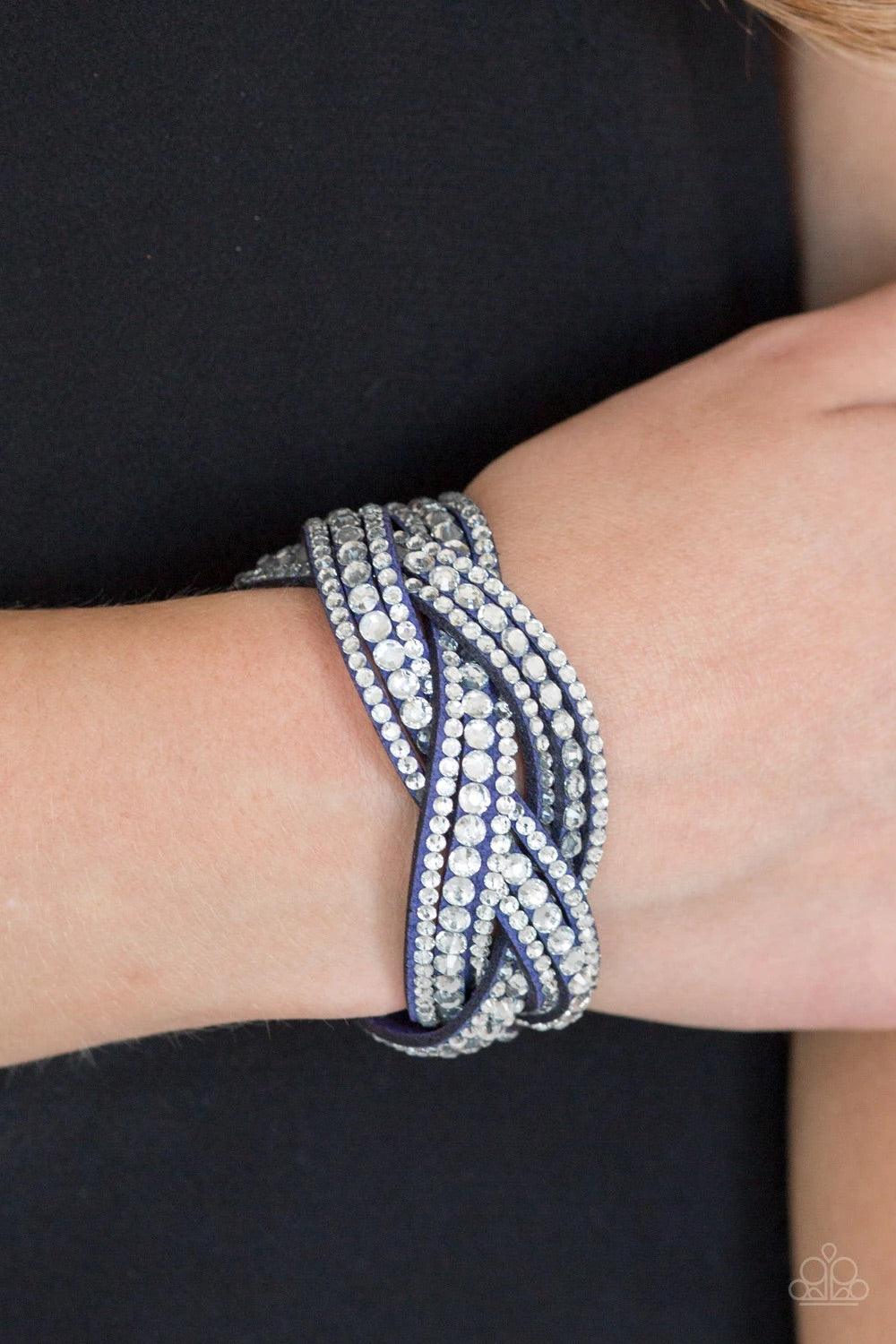 Paparazzi Accessories Bring on the Bling - Blue Varying in size, glassy white rhinestones are encrusted along interwoven blue suede bands, creating blinding shimmer across the wrist. Features an adjustable snap closure. Sold as one individual bracelet. Je