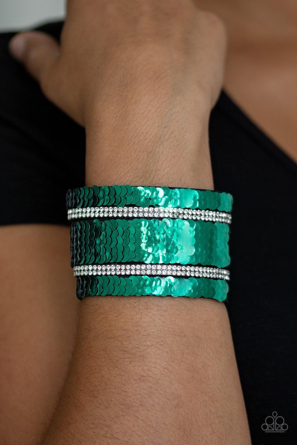 Paparazzi Accessories Mermaid Service - Green Infused with strands of blinding white rhinestones, row after row of shimmery sequins are stitched across the front of a spliced black suede band. Bracelet features reversible sequins that change from silver t