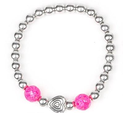 Paparazzi Accessories Starlet Shimmer Bracelet #13 - Pink Featuring silver heart charms, with a glassy colored bead. Jewelry