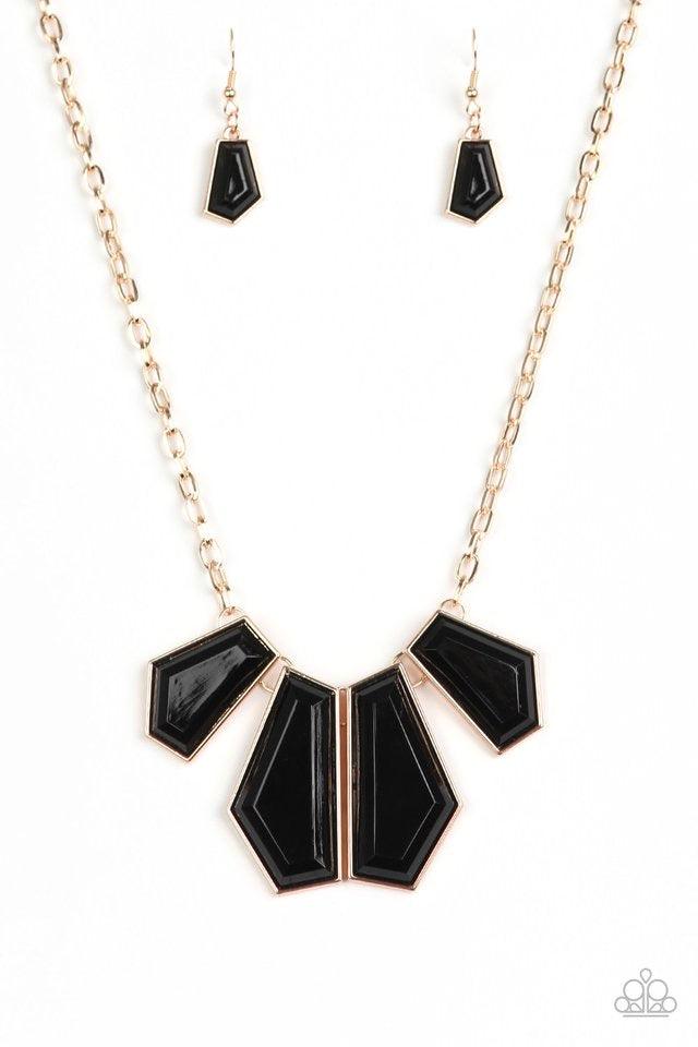 Paparazzi Accessories Get Up And Geo - Gold Featuring emerald-style cuts, faceted black beads are pressed into sleek gold frames. The colorful frames join at the bottom of a shimmery gold chain, creating a bold geometric fringe below the collar. Features