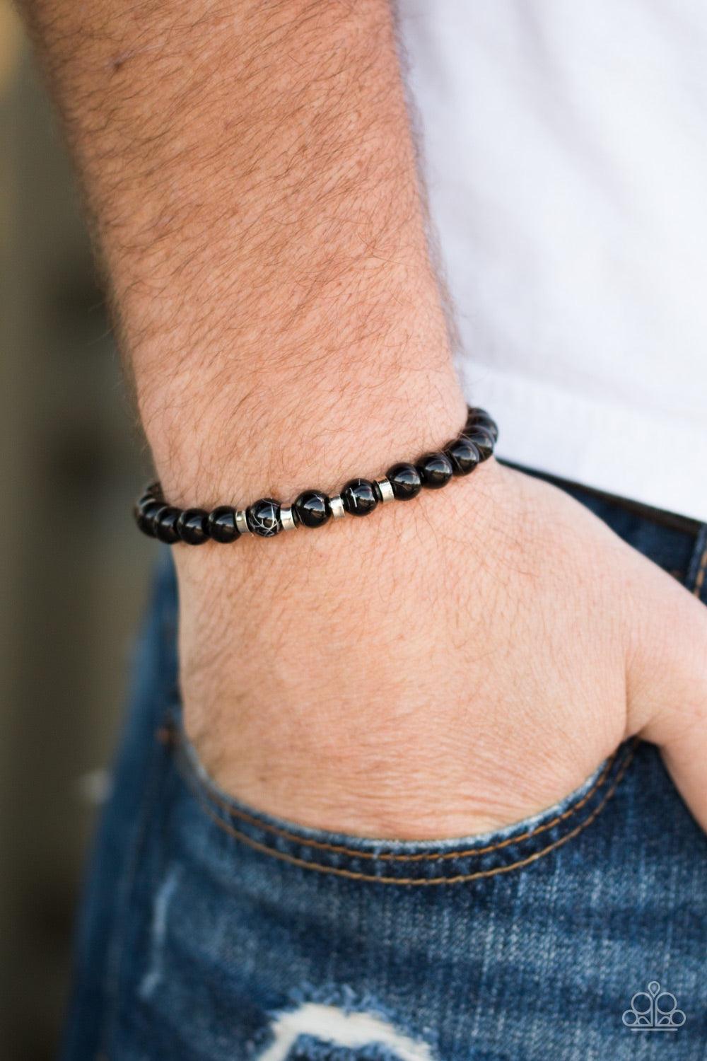 Paparazzi Accessories Composed - Black Glassy black beads are threaded along a stretchy elastic band for a seasonal look. Infused with silver accents, the shiny black beads are brushed in a metallic marble finish for an earthy finish. Jewelry