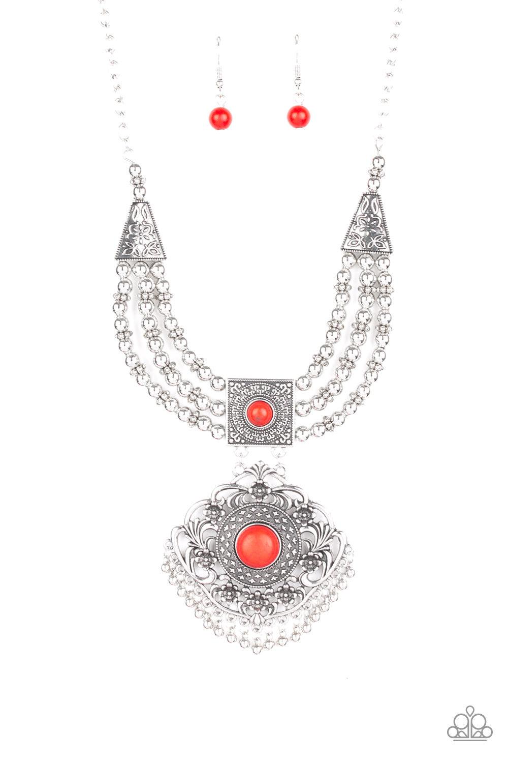 Paparazzi Accessories Santa Fe Solstice - Red Dotted with fiery red stone centers, two ornate frames link below the collar. Strands of silver beads are threaded through the uppermost pendant, adding an antiqued flair to the tribal inspired pendant. Featur