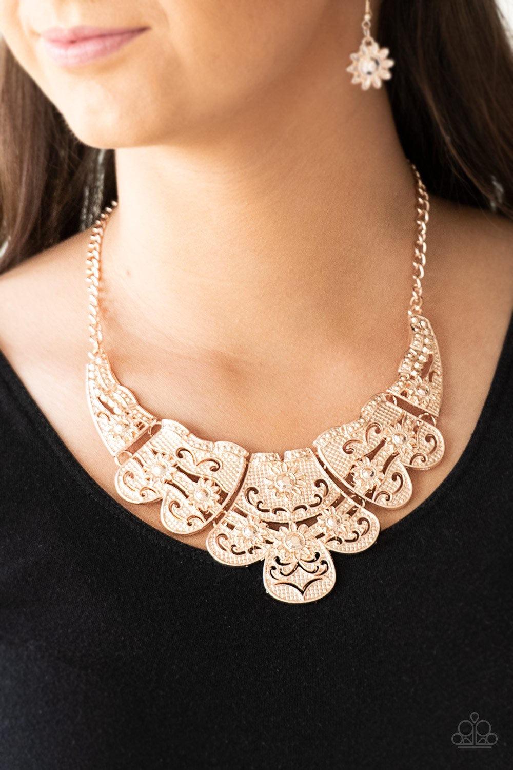 Paparazzi Accessories Mess With The Bull - Gold Embossed in whimsical floral detail, shimmery gold plates connect below the collar for a statement making look. Features an adjustable clasp closure. Sold as one individual necklace. Includes one pair of mat