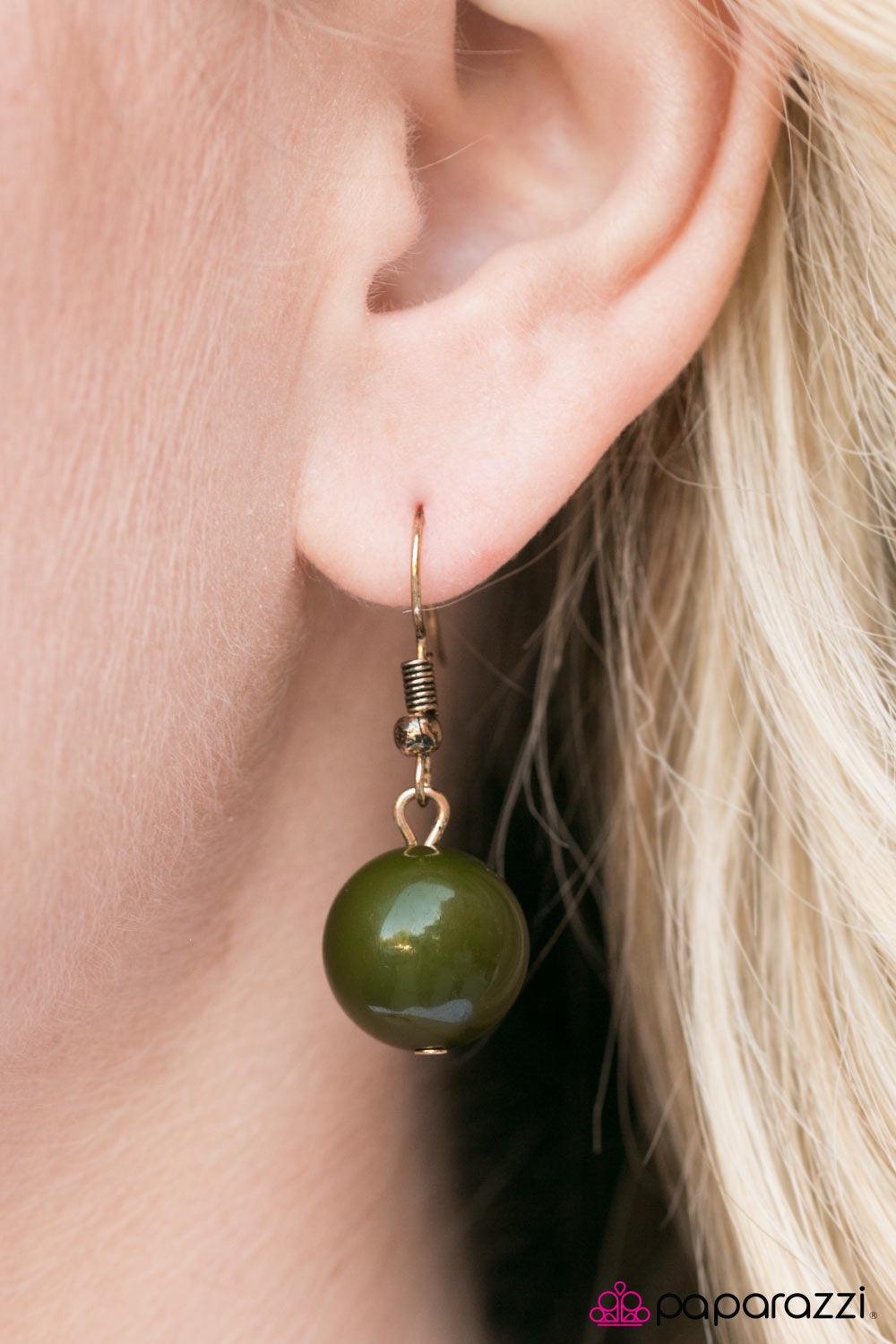 Paparazzi Accessories Egyptian Spell - Green Dramatic gold plates connect with a shiny green circle, creating an indigenous collar-like pendant. Brushed in an antique shimmer, spun ribbons of gold embellish the plates, adding a flashy metallic texture to