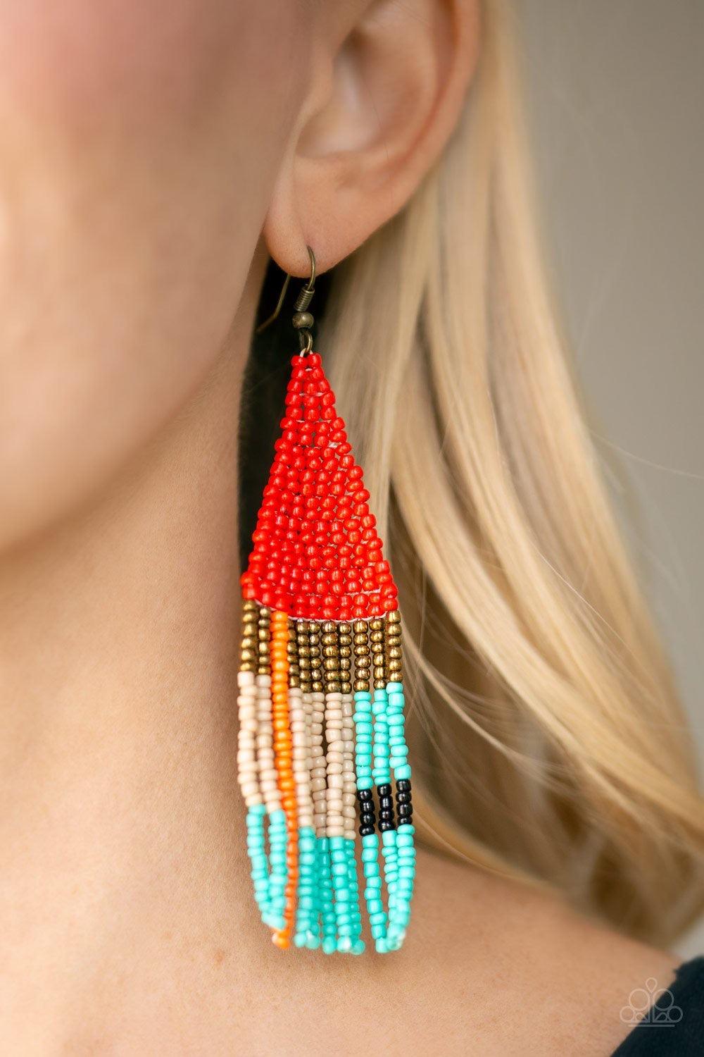 Paparazzi Accessories Beaded Boho - Red Featuring red, brass, orange, blue, black, and brown seed beads, dainty beaded tassels swing from a beaded triangular frame for a colorful tribal look. Earring attaches to standard fishhook fitting. Jewelry