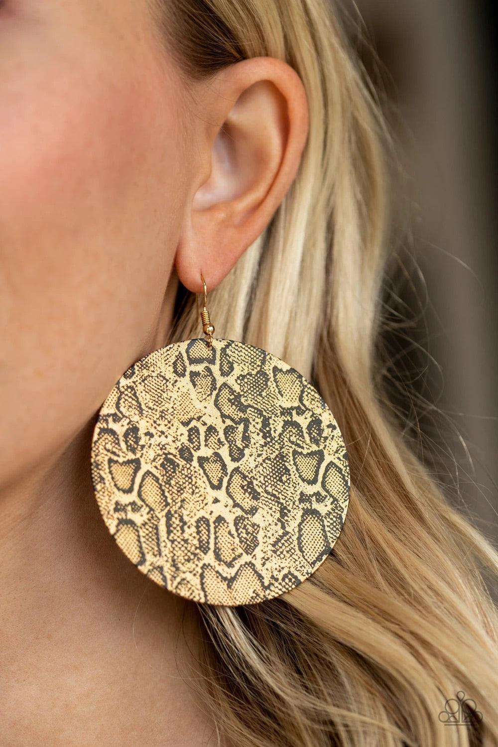 Paparazzi Accessories Animal Planet - Gold Featuring black python print on the front and back, an oversized gold disc swings from the ear for a wild look. Earring attaches to a standard fishhook fitting. Sold as one pair of earrings. Jewelry