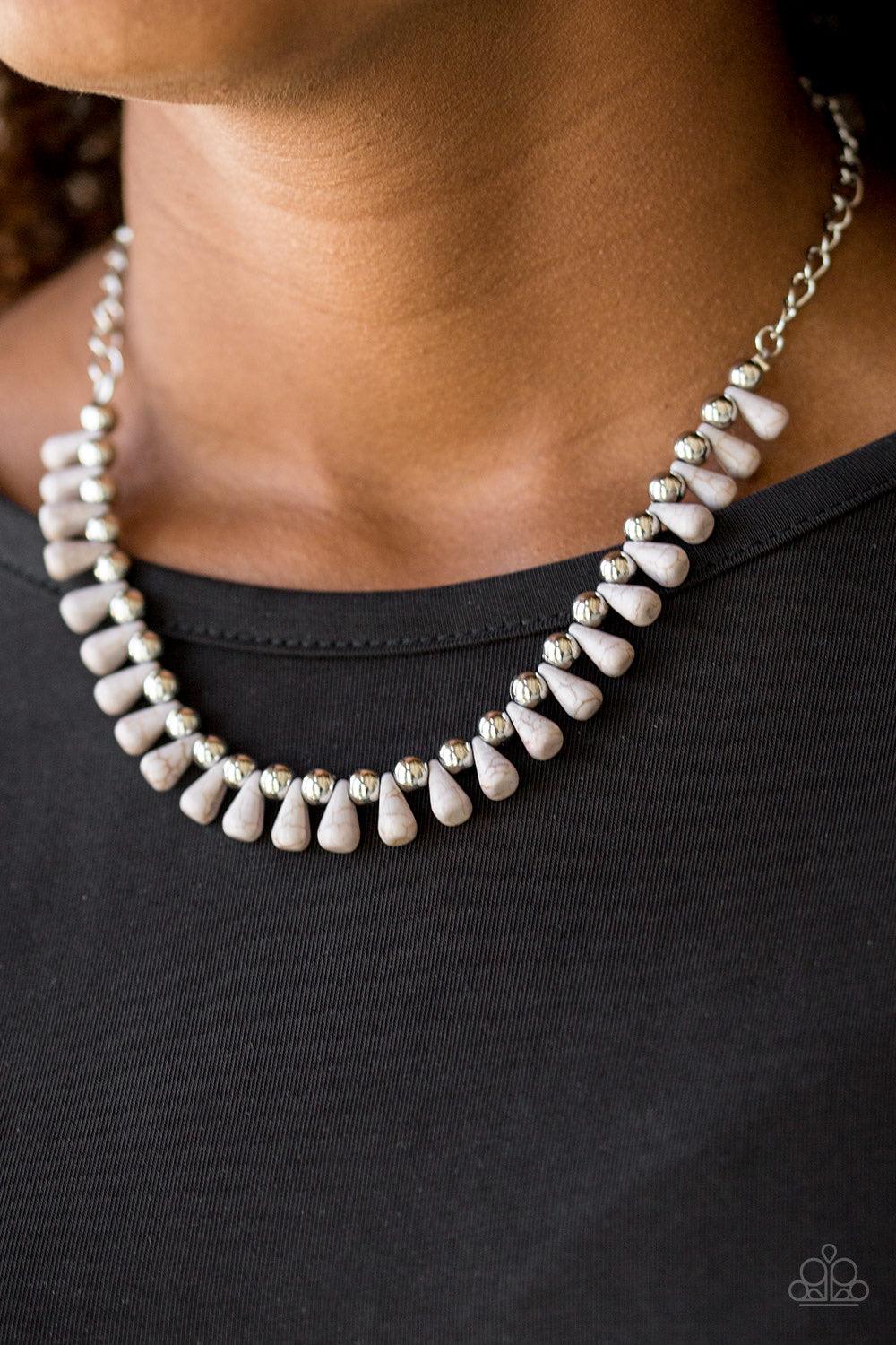 Paparazzi Accessories Extinct Species - Silver Gray teardrop stones and classic silver beads are threaded along an invisible wire. The earthy beads alternate below the collar, creating a wild fringe. Features an adjustable clasp closure. Sold as one indiv