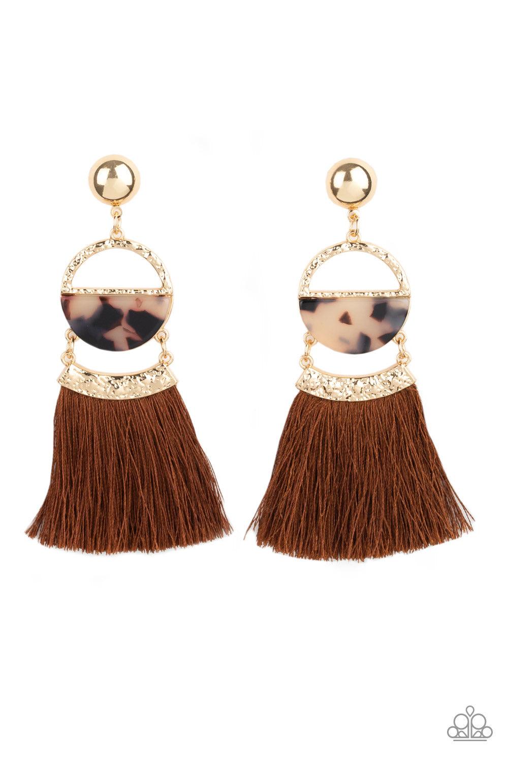 Paparazzi Accessories Tassel Trot - Brown A shimmery gold stud links with a hammered gold frame featuring a tortoiseshell print acrylic accent. Featuring a hammered gold fitting, a shiny brown threaded tassel attaches to the bottom of the retro lure for a