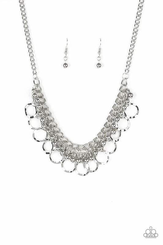Paparazzi Accessories Ring Leader Radiance - Silver Rows of shiny silver beads and hammered rings swing from the bottom of interlocking silver chains, creating a bold fringe below the collar. Features an adjustable clasp closure. Sold as one individual ne