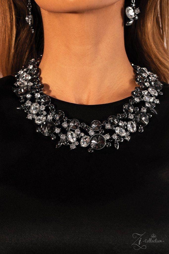 Paparazzi Accessories Phenomenon Encased in shimmery metallic frames, clusters of glassy white rhinestones and mysterious smoky gems in a range of sizes and shapes wrap dramatically around the collar in a show-stopping finish. Sleek gunmetal accents are s
