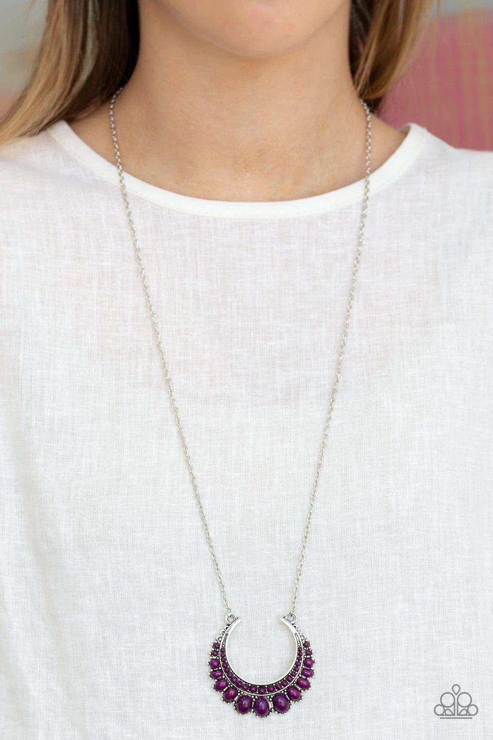 Paparazzi Accessories Count To Zen A- Purple Gradually increasing in size towards the center, dainty purple beads are encrusted along the center of a silver crescent frame. Purple beads flare out from the bottom of the shimmery silver frame, creating a bo