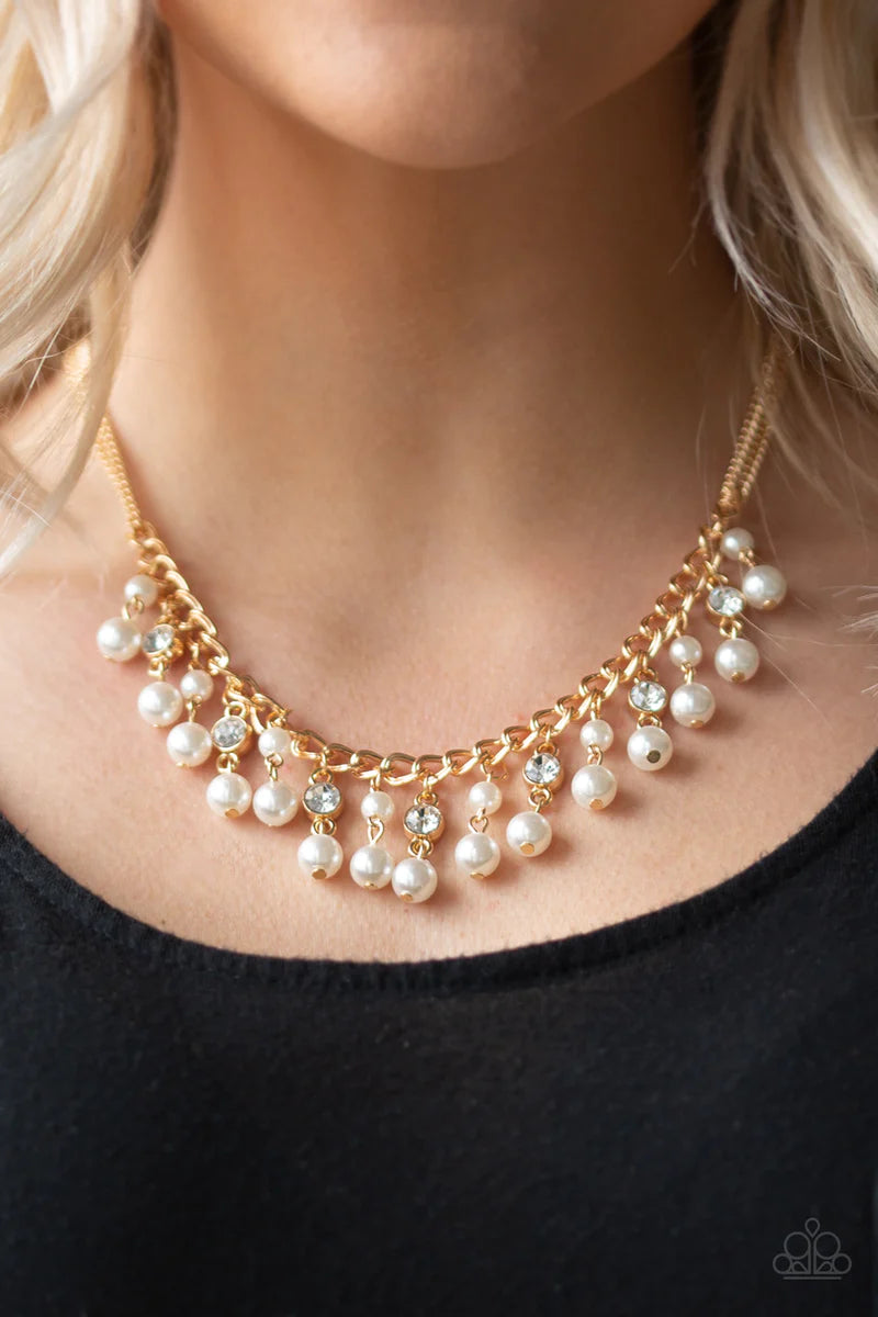 Paparazzi Accessories Regal Refinement - Gold Alternating with glassy white rhinestones, pearly white beaded tassels swing from the bottom of a shimmery gold chain below the collar for a refined flair. Features an adjustable clasp closure. Sold as one ind