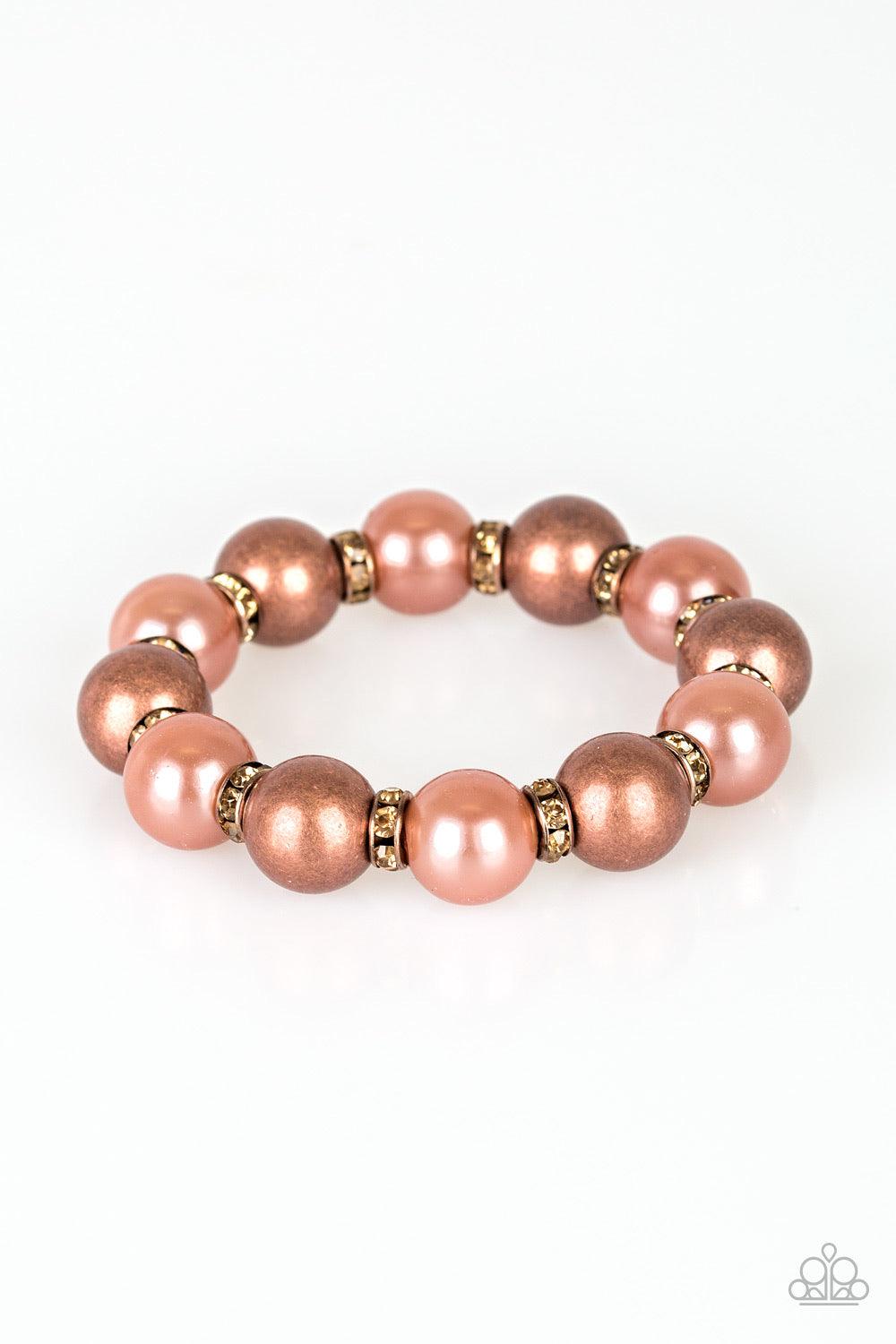 Paparazzi Accessories So Not Sorry - Copper A collection of topaz rhinestone encrusted rings, pearly copper beads, and classic copper beads are threaded along a stretchy band around the wrist for a glamorous look. Jewelry