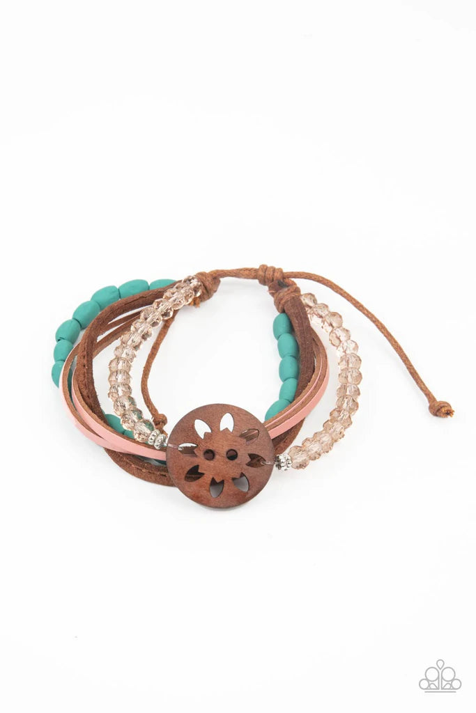 Paparazzi Accessories Desert Gallery - Blue Featuring a wooden floral centerpiece, mismatched strands of turquoise wooden beads, pink leather, brown suede, and topaz crystal-like beads layer across the wrist for a seasonal flair. Features an adjustable sl