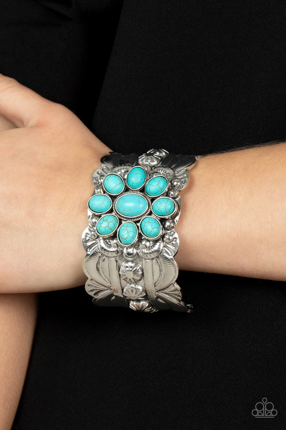 Paparazzi Accessories Southern Eden - Blue Refreshing turquoise stones adorn the center of a substantial silver cuff that is studded and embossed in scalloped and sunburst accents, creating a floral centerpiece around the wrist. Sold as one individual bra