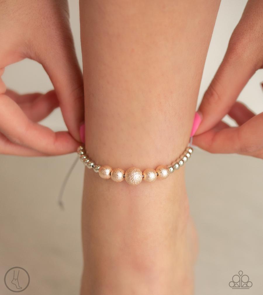 Paparazzi Accessories Beach Zen - Multi A collection of dainty silver and hammered rose gold beads slide along a shiny gray cord around the ankle for a whimsical look. Features an adjustable sliding knot closure. Jewelry