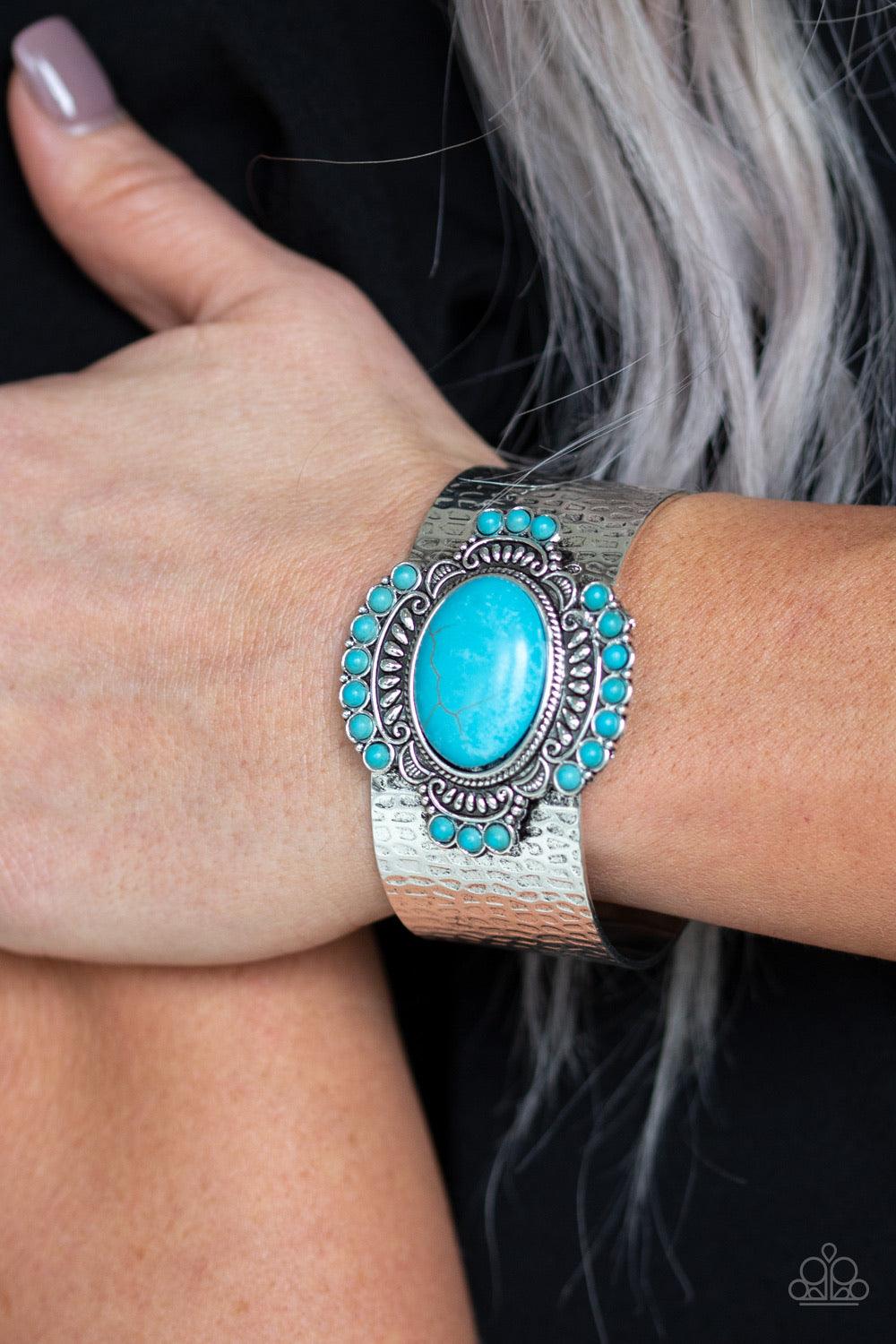 Paparazzi Accessories Canyon Crafted ~Blue Radiating with refreshing turquoise stones and tribal inspired patterns, an ornate stone frame is pressed into the center of a hammered silver cuff for an artisan flair.
