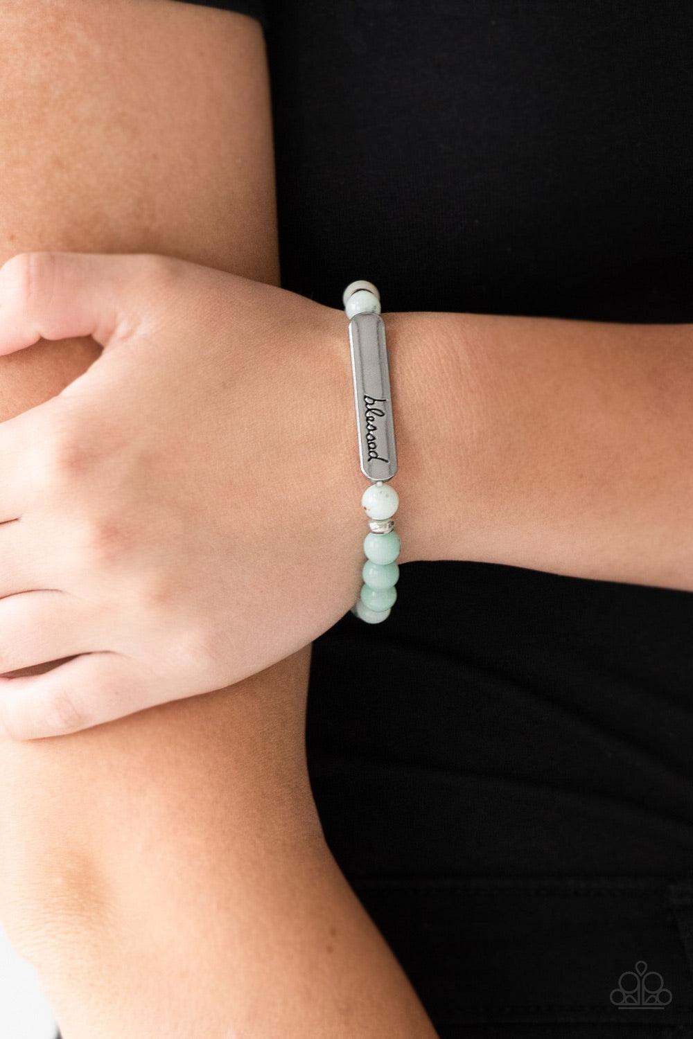 Paparazzi Accessories Born Blessed - Green Infused with dainty silver accents, a collection of colorful natural stones are threaded along a stretchy band. A glistening silver frame engraved with the word, "blessed" adorns the center for a seasonal finish.