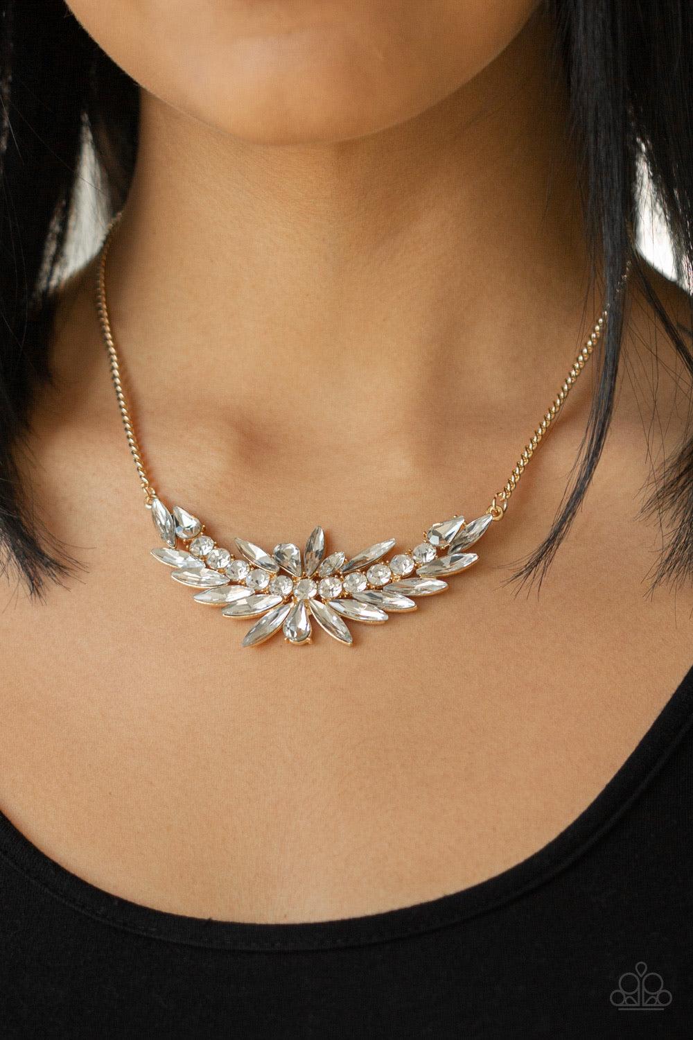 Paparazzi Accessories HEIRS and Graces - Gold Featuring round, marquise, and teardrop style cuts, a glassy collection of glittery white rhinestones coalesce into a blinding gold pendant below the collar. Features an adjustable clasp closure. Jewelry