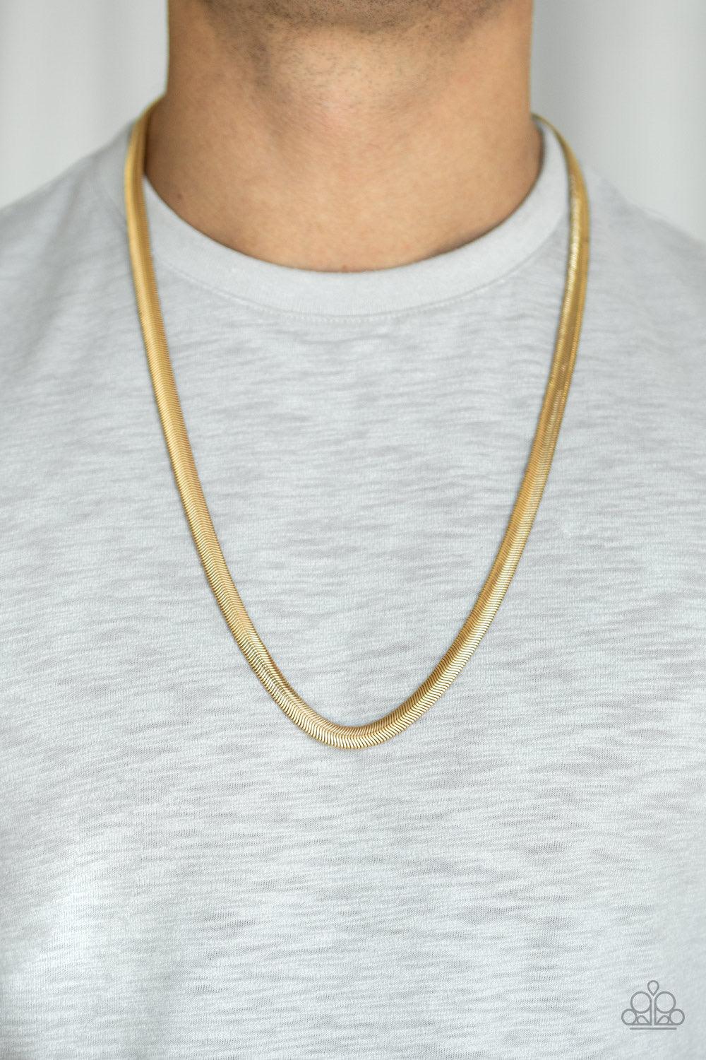 Paparazzi Accessories Kingpin - Gold Featuring a high-sheen finish, a thick gold herringbone chain drapes across the chest for a sleek, upscale look. Features an adjustable clasp closure. Jewelry