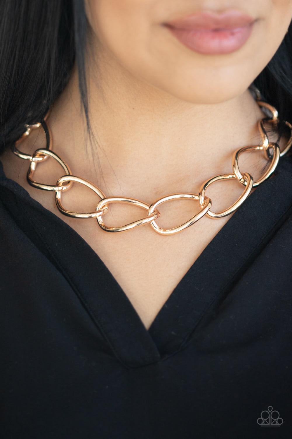 Paparazzi Accessories The Challenger - Gold Dramatically oversized gold links connect below the collar for an exaggerated industrial style. Features an adjustable clasp closure. Jewelry